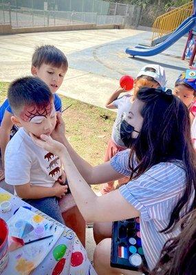 Face painting at the park for the birthday boy