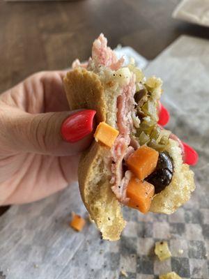 Savoring the last bites of this muffuletta!!!! Yum!