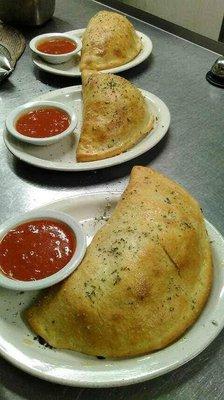 Calzone stuffed with ricotta and mozzarella cheese served with a side of marinara sauce.