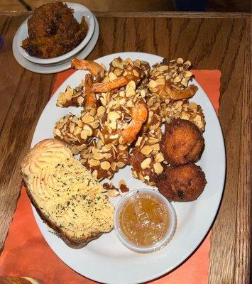 almond shrimp with Sweet potatoe casserole, twice baked potato, and hush puppies.