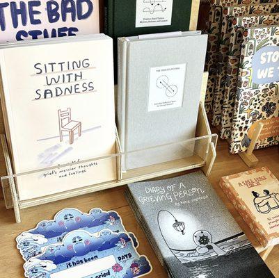 Another corner of our shop with zines, card decks, and prompted journals.