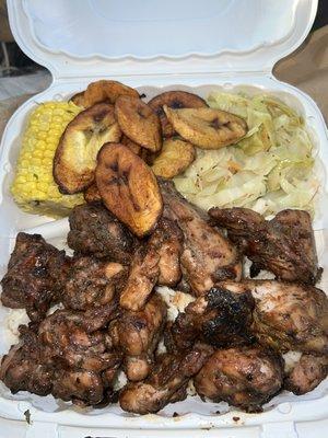 Jerk chicken, steamed cabbage, Fried Plantains, Corn & rice and peas