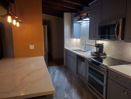 The light over the sink was custom built for us by Robert. And he made sure we got under cabinet lights throughout!