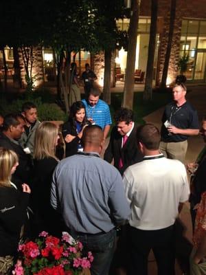 Magician Richard Steele gathering a crowd at a corporate event.