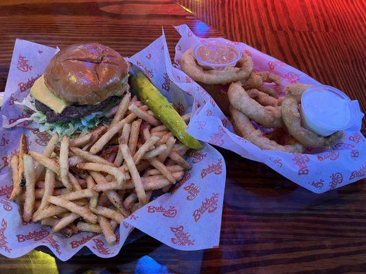 Classic burger with seasoned fries, and a side of onion rings