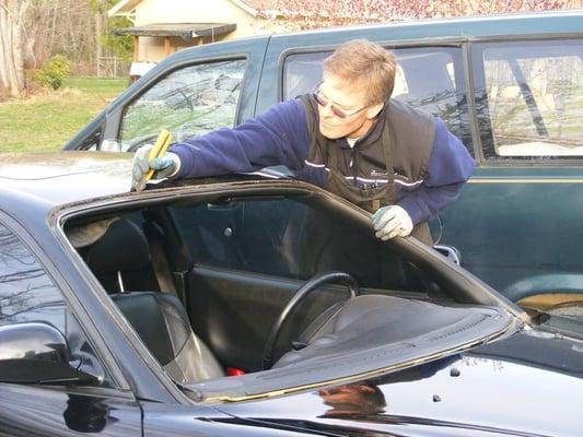 Walt Mayne installing a windshield at a customer's home.