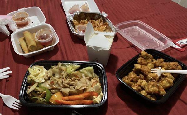 Drunken noodles, veggie egg rolls, crab ragoons, and orange chicken.