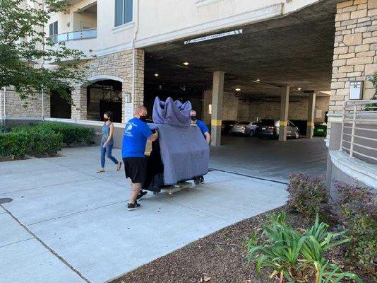 Moving piano from truck into building