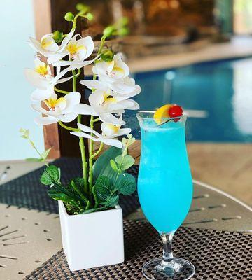 Try our Blue Lagoon cocktail by poolside