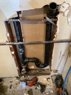 Cut out old standpipe that was leaking for an existing laundry drain. Install new tucking it in the wall no longer exposed