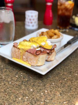 Traditional eggs Benedict with potatoes.