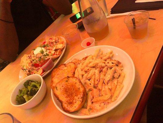 Cajun chicken and shrimp Alfredo with a side of broccoli and chicken nachos