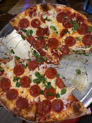 Large pepperoni and green pepper pizza.