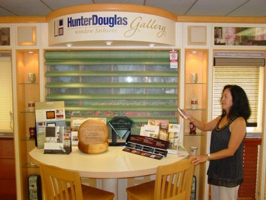 Mary Ann showing a motorized Pirouette shade by Hunter Douglas in our showroom.