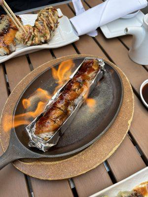 Flaming Dragon Roll - shrimp tempura, avocado, cream cheese, topped with bbq eel, eel sauce (served over flames)