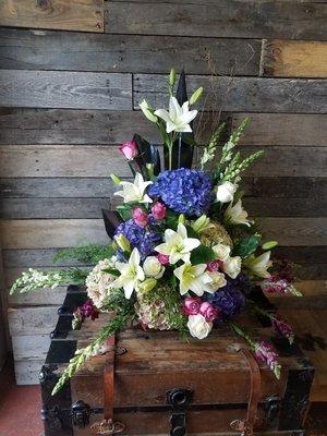 An altar arrangement with antique hydrangeas,  lilies and snapdragons