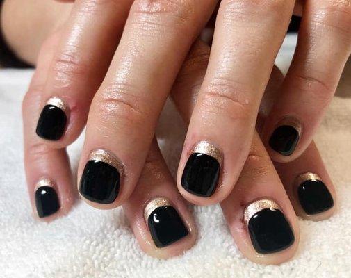 Shellac manicure in Black Pool with gold cuffs.