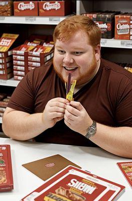 The humongous store owner stealing and eating my Slim Jim with a joyous smile on his evil face!