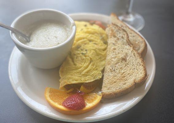 Fiesta omelet (turkey sausage, jalapeños, grilled peppers, and cheddar cheese) w/ side of cheddar grits