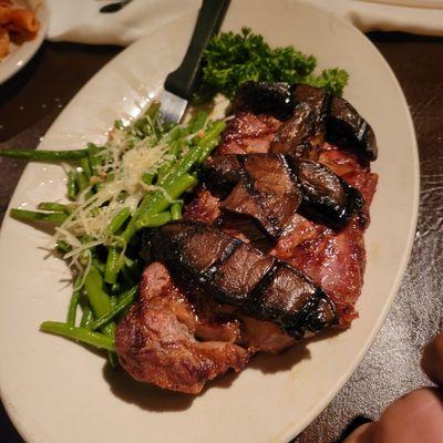 Steak topped with mushrooms