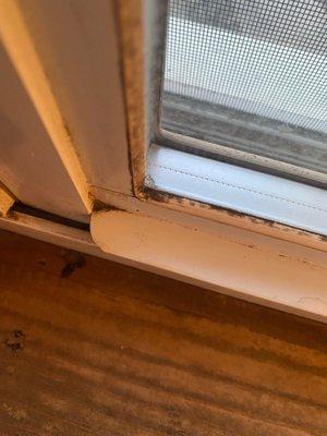 Dirt left on corners of window sill.