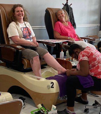 My sister and I getting pampered with pedicures while our other sister got a manicure