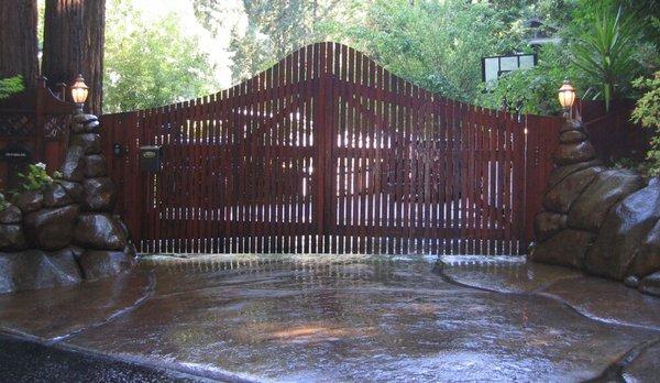 Automatic gates with rock columns and  10,000 square feet of rock stamped concrete driveway. Acid stained with satin lacquer.