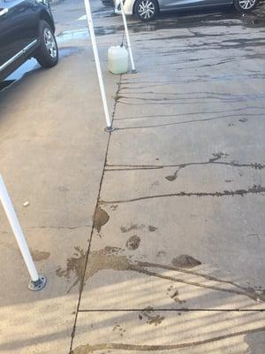 Huge leak seeping out of the ground on a parking lot