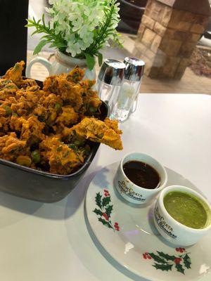 Mixed vegetable pakora (fried vegetable fritters) with two dipping sauces