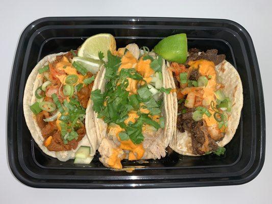 Spicy Pork, Spicy Chicken and Bulgogi Tacos topped with spicy mayo sauce.