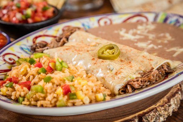 Brisket Enchiladas
Two slow smoked brisket enchiladas wrapped in homemade flour tortillas and topped with queso blanco.