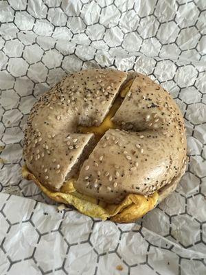 Toasted whole wheat everything bagel with egg and cheese