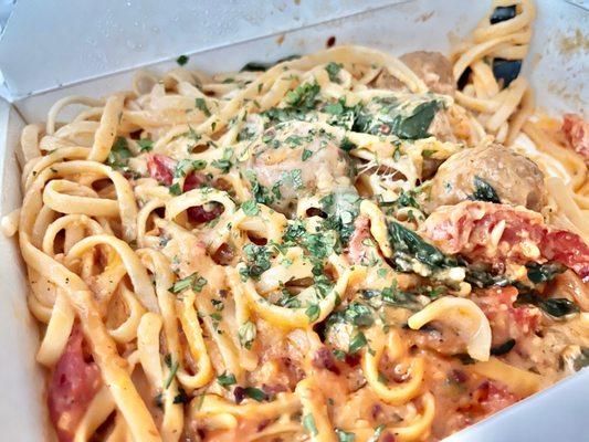 Fettuccine with pink sauce, spinach, dried tomatoes, meatballs. Yummy