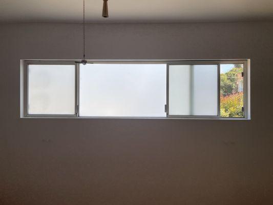 Master bedroom window, with new frosted privacy film.