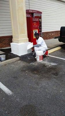 One of our plasterers putting the final touches on this column, using conventional Stucco.