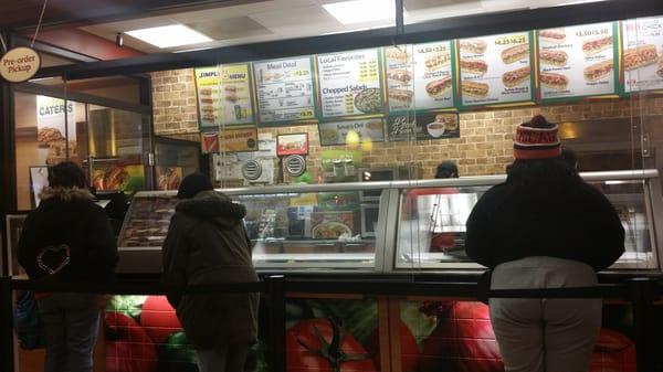 As you can see the tall glass barrier does open. It actually often stays open at this Subway location.