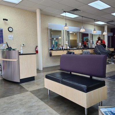 Main cashier area, comfortable bench, and cutting hair area.