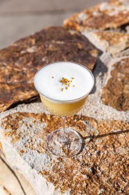 The Pollenator with bee pollen-infused capel pisco, vieux pontarlier absinthe, egg white, rose water + lime