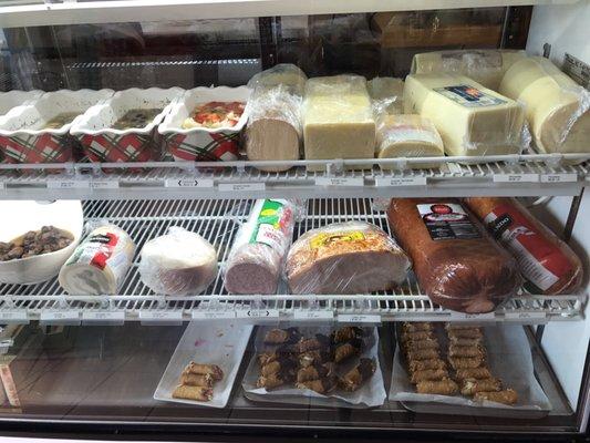 Fridge display. Yummy pastas, cheeses, meats, and treats