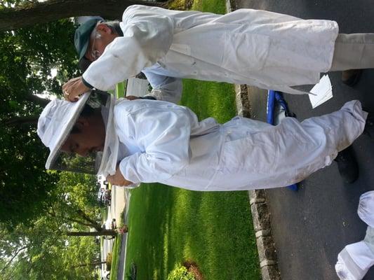 Bert (father) helps Steven (son) put on the protective bee suit. We take no chances on safety especially with two active nests at this site.