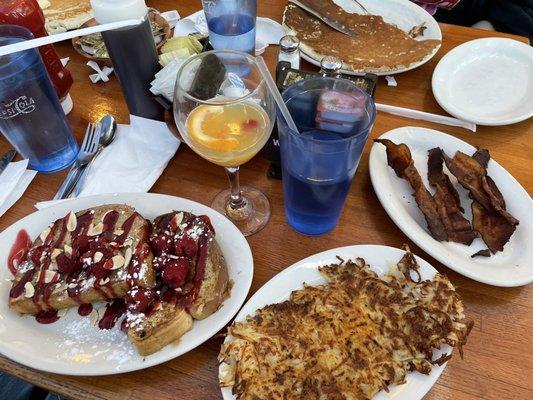 Raspberry/Almond French Toast, crispy hash browns, crisp bacon, and a mimosa