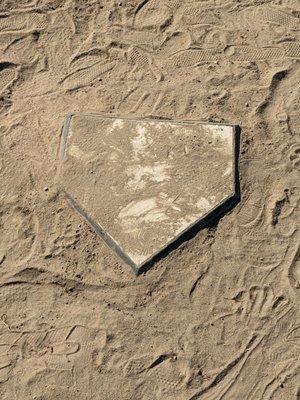 Home plate in front of the backstop