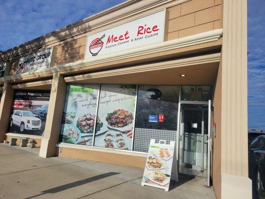 Meet Rice store front. It's on a corner and they have a small parking lot in the back.