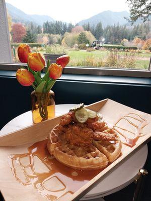 Nashville Chicken and Waffles with Cayenne waffles served with spicy Nashville chicken, dill pickle compound butter, hot honey maple syrup