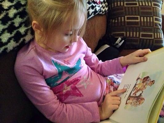 My daughter reading Dick and Jane