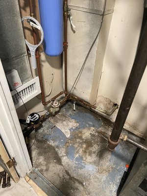 Utility closet with hot water tank removed.