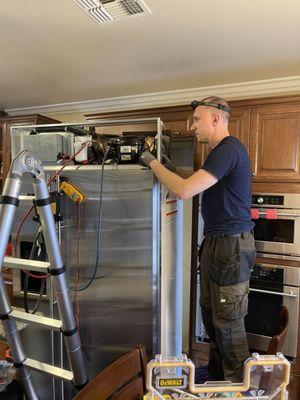 Servicing a build in refrigerator for our customer