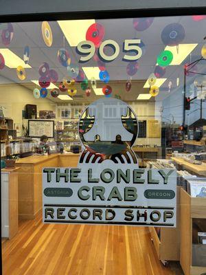 Lonely crab record shop front door sign and address