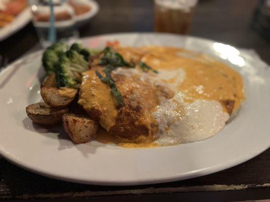 Chicken Parmigiana with vodka sauce and potatoes and vegetables