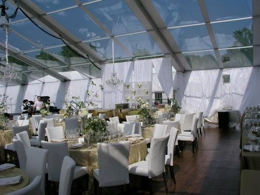 Structure Tent with Clear Top, White Leather Slipper Chairs, Gold Sheer Floor Lenth Linen, Hardwood Flooring